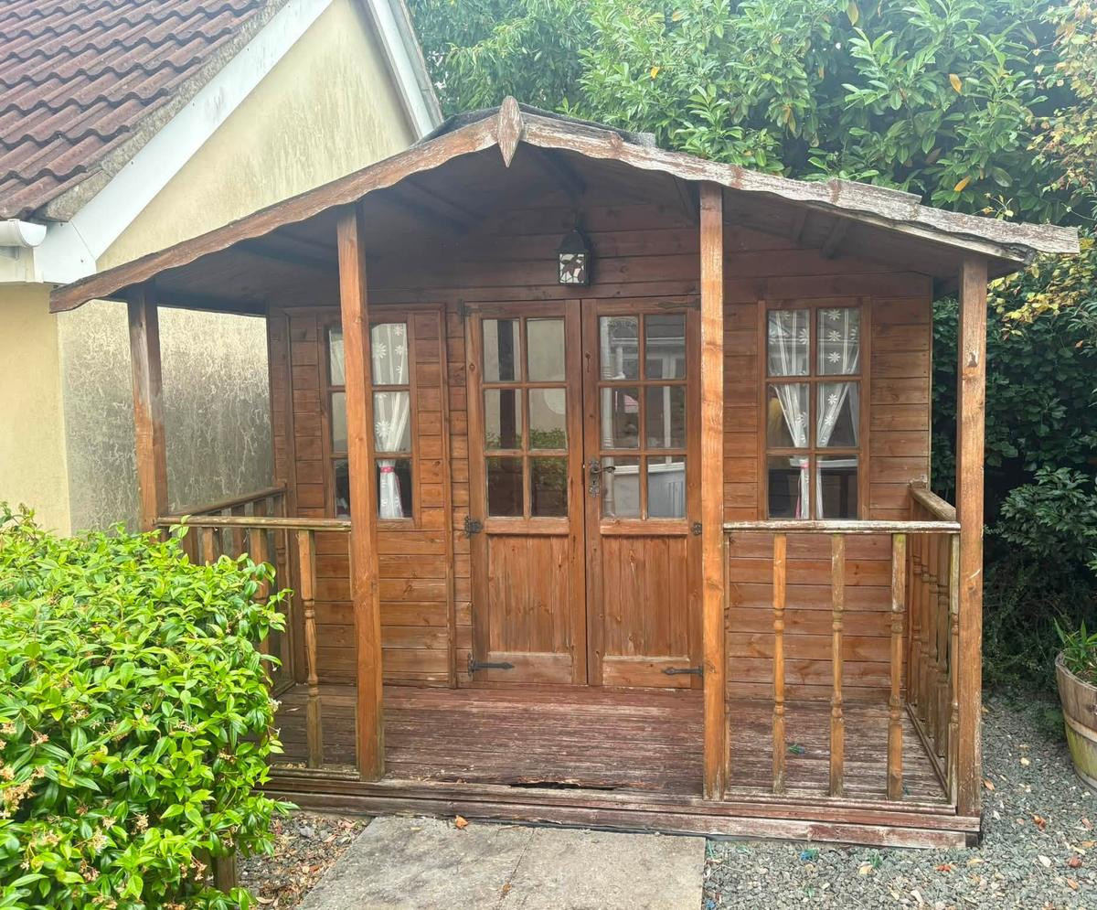 Summerhouse before: weathered timber and a rotten floor